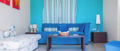 A living room with a sofa, a coffee table, and a side table.
