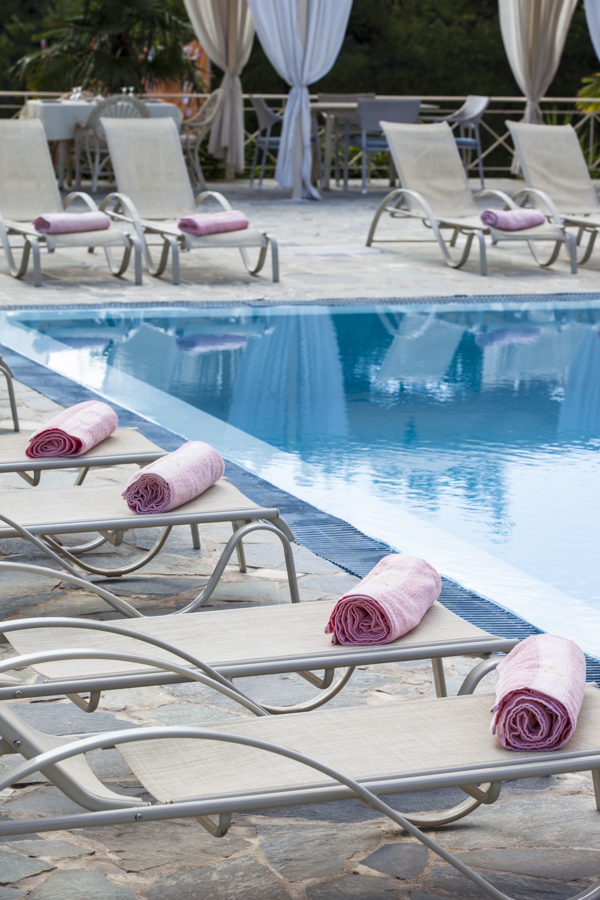 A poolside area with lounge chairs and towels.
