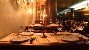 A restaurant table set with plates, glasses, and cutlery.
