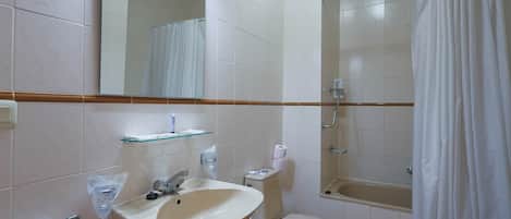 A bathroom with a sink, toilet, and shower.