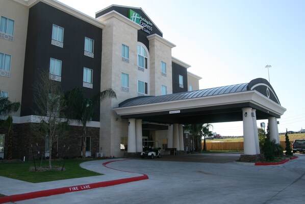 Guests can enjoy a pleasant stay at this hotel, surrounded by a well-maintained lawn and trees.