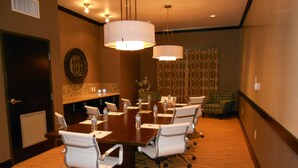 A conference room with a large table, white chairs, and overhead lighting. - Holiday Inn Express and Suites Corpus Christi North by IHG (Corpus Christi)