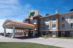 A Holiday Inn Express & Suites hotel with a covered entrance, multiple windows, and a stone facade. - Holiday Inn Express & Suites Wichita Northwest by IHG (Maize)