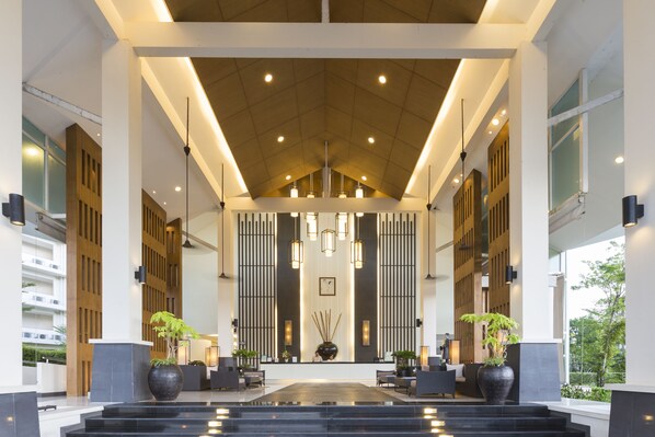 A spacious lobby with a high ceiling, modern lighting, and a central reception desk. - Kantary Beach Hotel Villas & Suites, Khao Lak (Takua Pa)