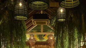 An indoor setting with hanging wicker lamps, a bar area, and seating arrangements. - The Peri Hotel Hua Hin (Hua Hin)