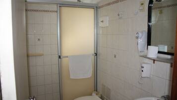 A bathroom with a toilet, a sink, a towel rack, and a shower.