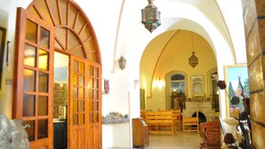 An interior with arched ceilings, wooden furniture, and a fireplace. - Azzahra Boutique Hotel & Restaurant - Jerusalem (Jerusalem)