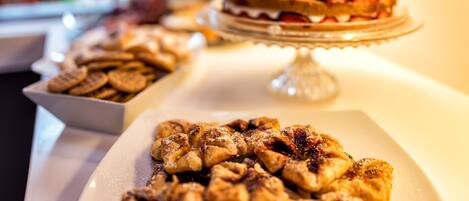A dessert table with a variety of pastries and a decorated cake.