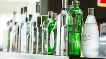 A variety of liquor bottles on a shelf.
