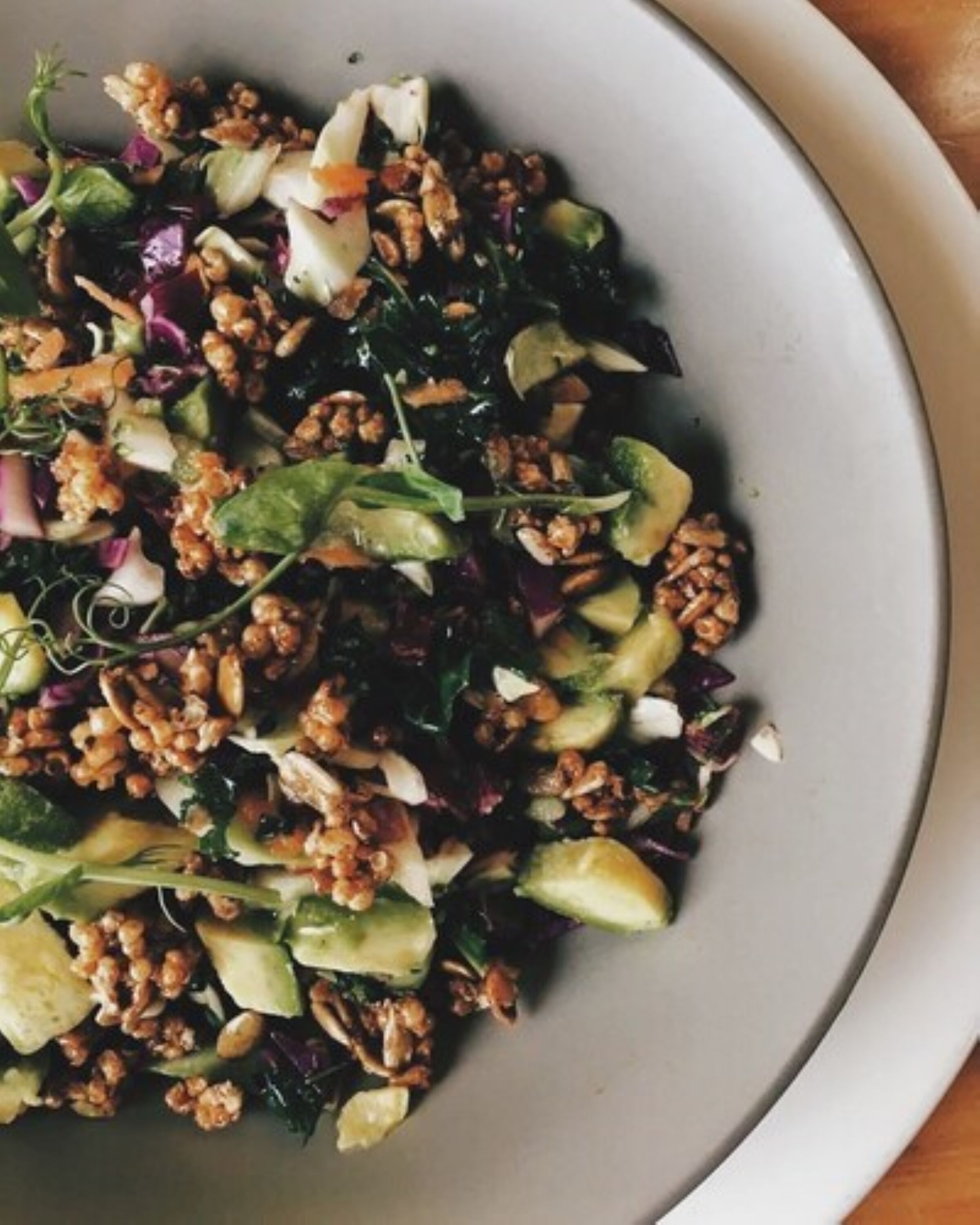 A plate of mixed greens and nuts.
