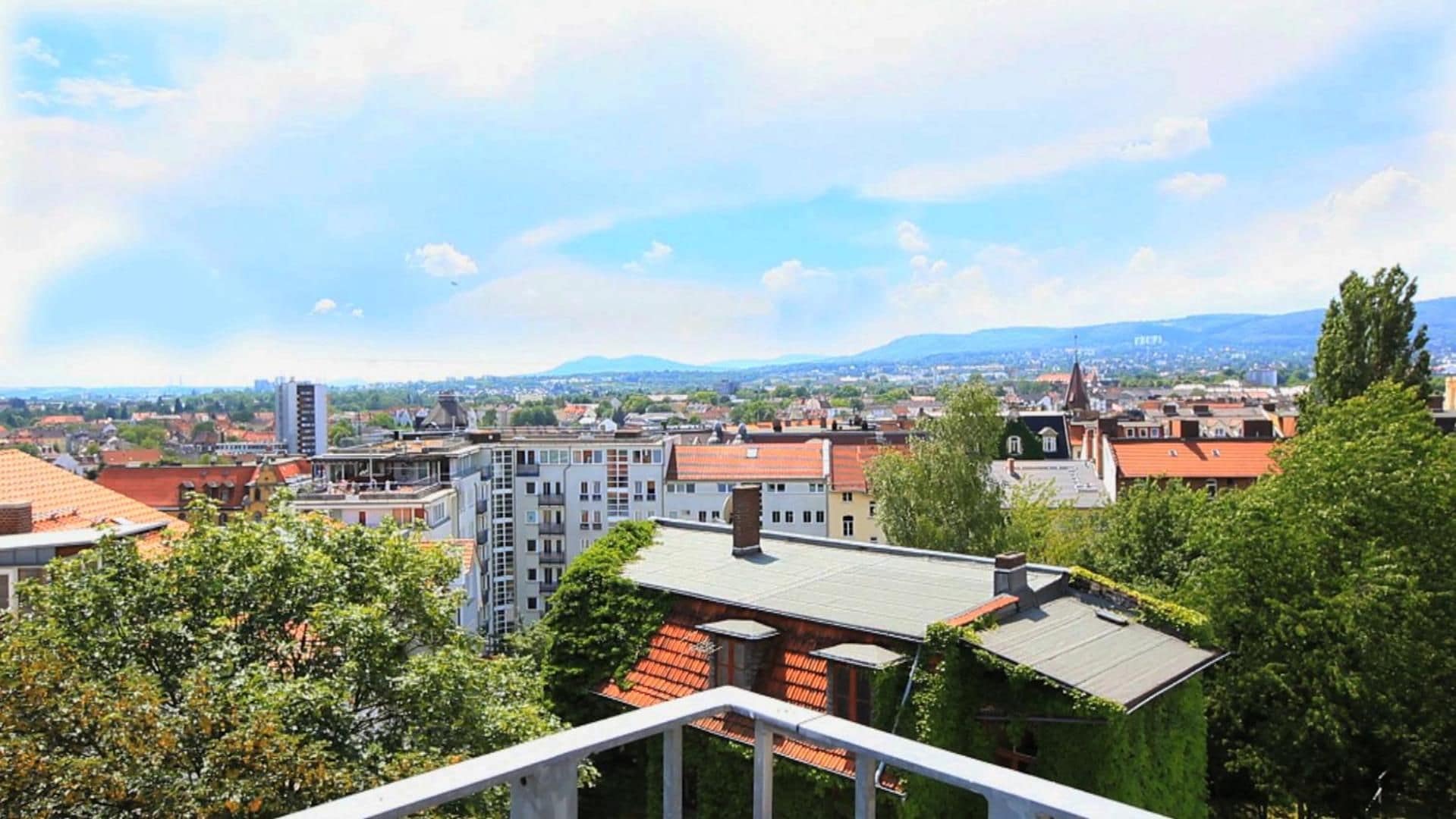 A cityscape with a variety of buildings, including residential and possibly commercial structures, under a clear sky.