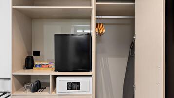 A hotel room with a minibar, a coffee machine, and a control panel for the minibar.