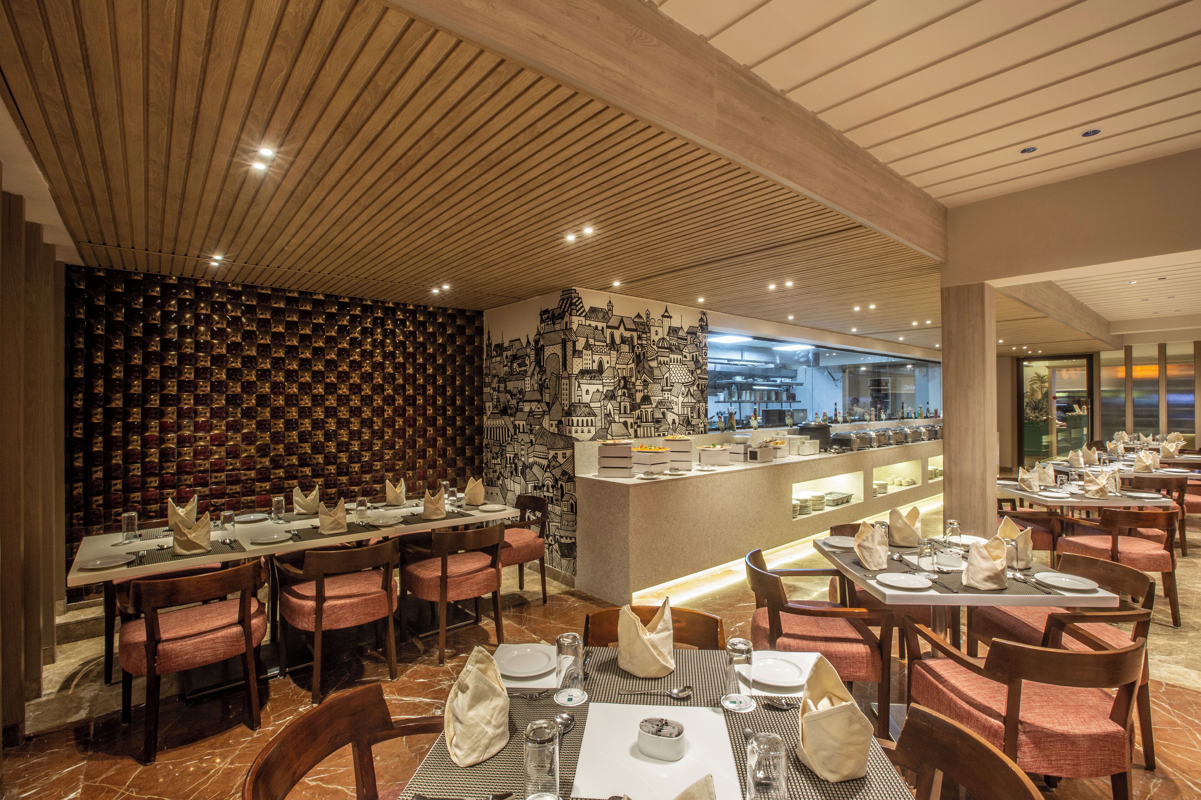 A restaurant with wooden ceiling beams, a patterned wall, and a view of the cityscape.