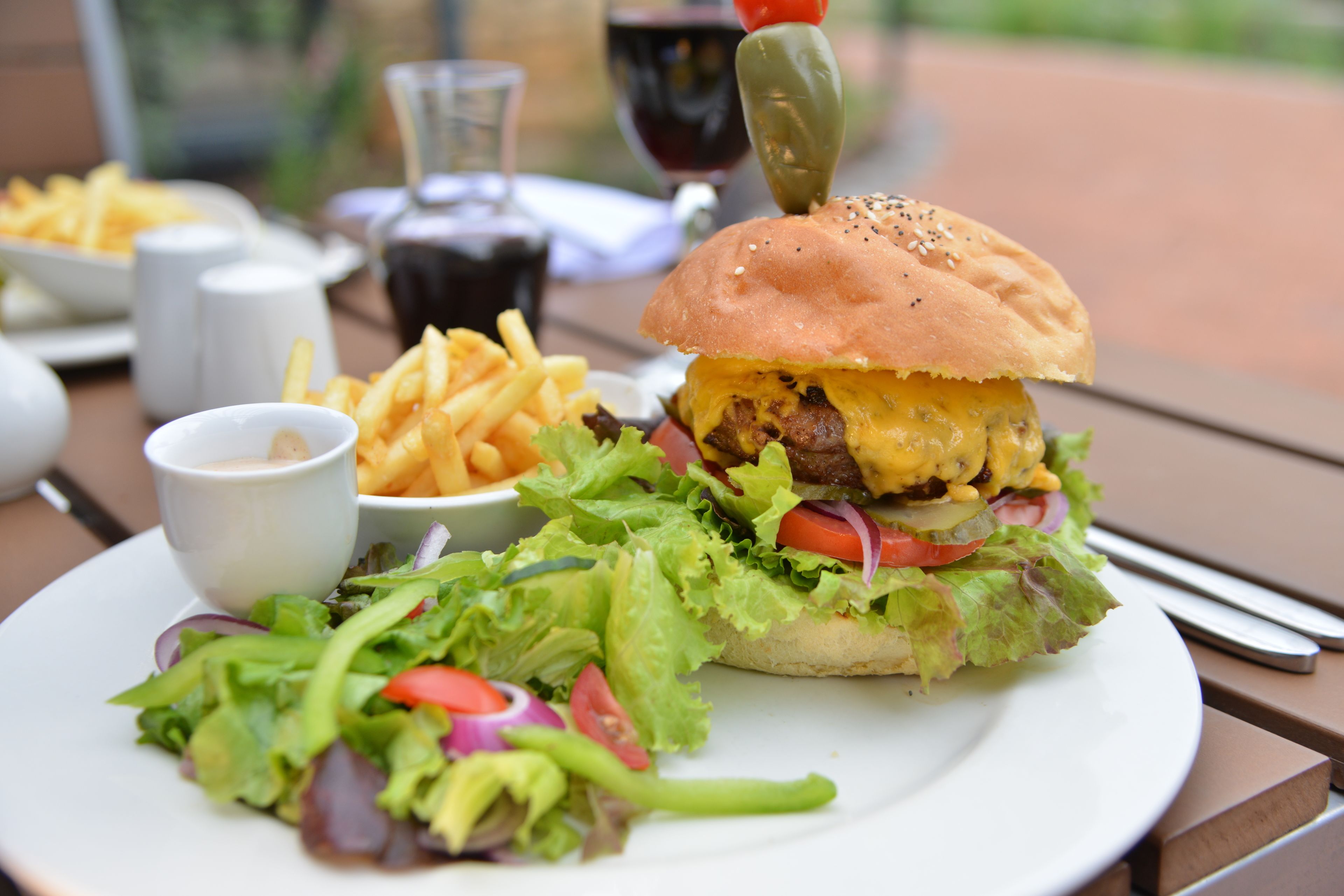 A plate with a burger, fries, and a salad.
