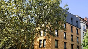 A multi-story building with a prominent entrance labeled "Hotel Sixteen." - Hotel Sixteen Paris Montrouge (Montrouge)