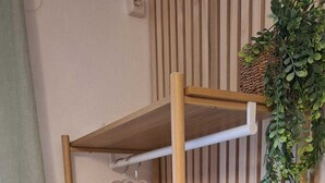 A wooden bunk bed with a woven basket on the lower shelf and a hanging heart-shaped item on the top shelf. - Apartmani Teo (Hvar)