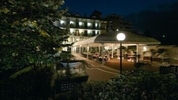 A building with a covered outdoor area, possibly a restaurant or lounge, with tables and chairs. - Hotel Civita (Atripalda)