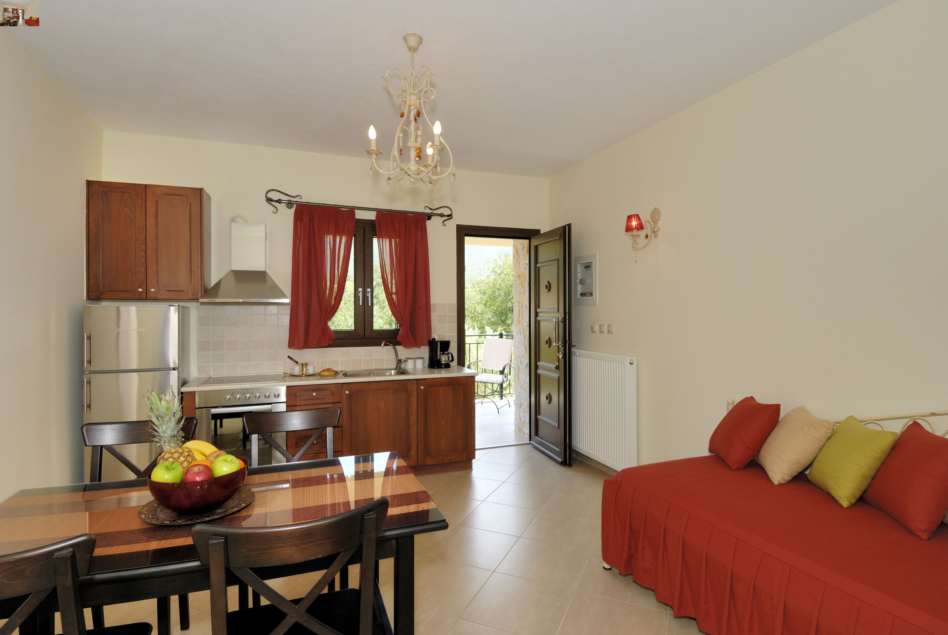 A compact living space with a dining area, kitchenette, and a sofa.