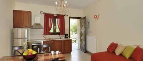 A compact living space with a dining area, kitchenette, and a sofa.