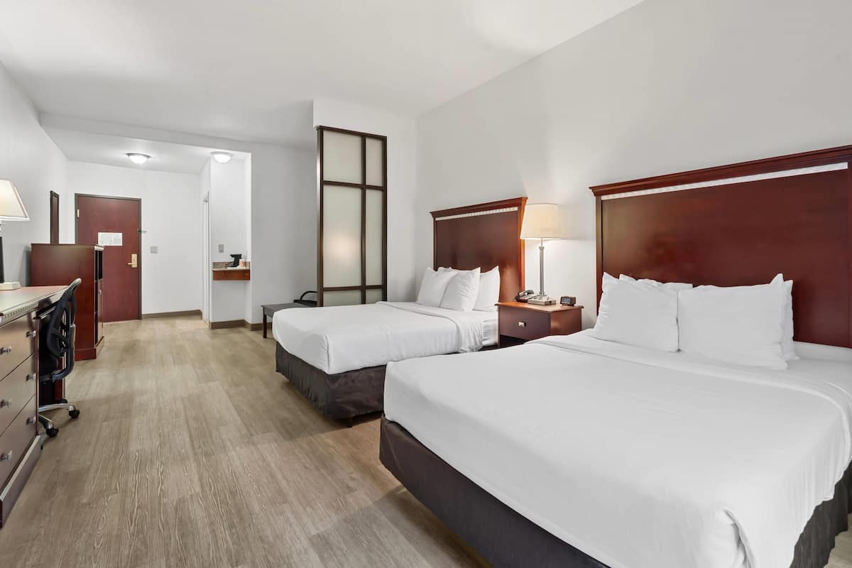Suite, Non Smoking (2 Queen Beds, 1 Double Sofa Bed) | Pillow-top beds, in-room safe, desk, laptop workspace