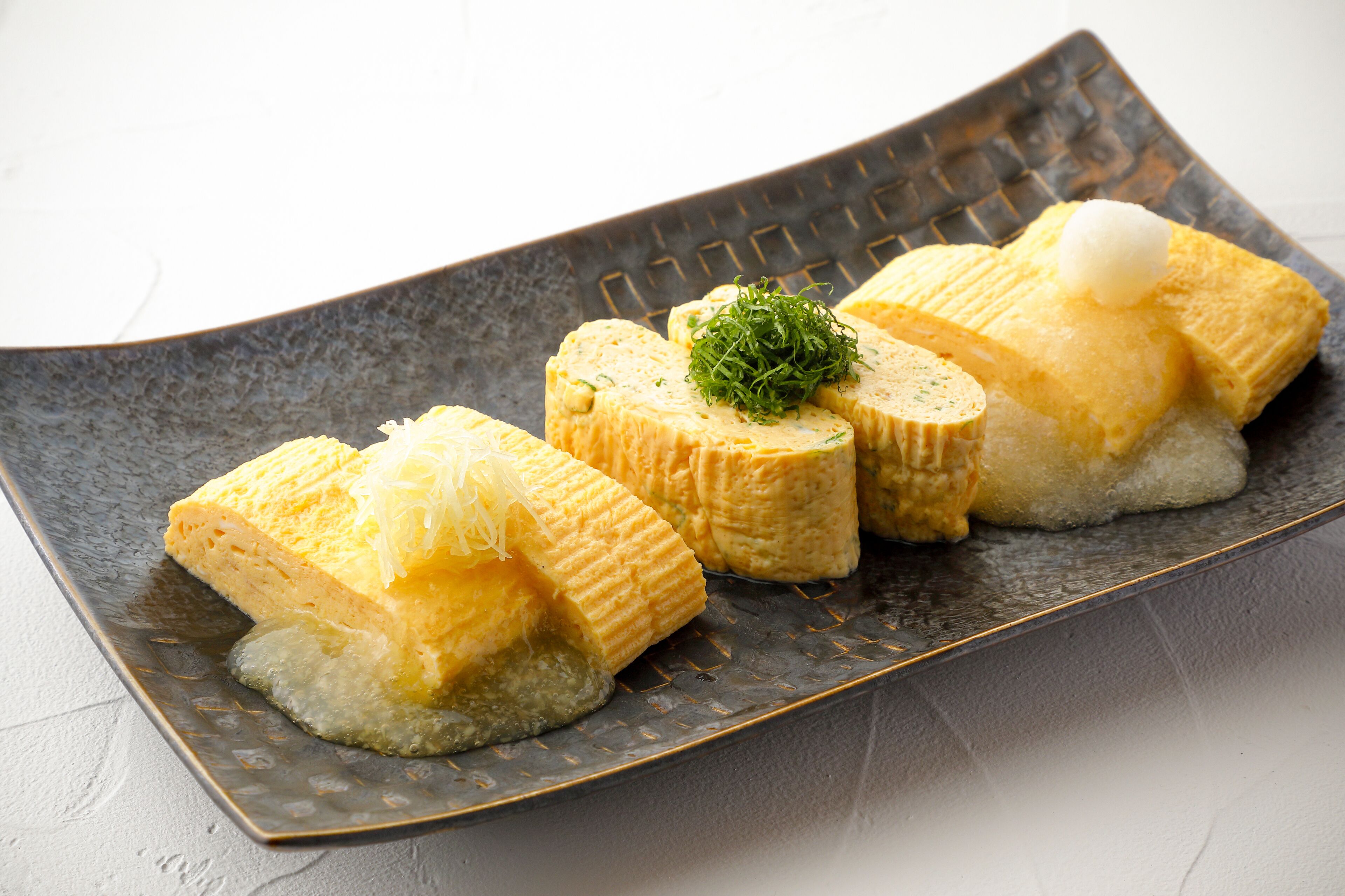 A plate of sushi with a decorative garnish.