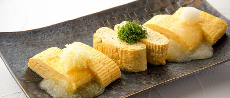 A plate of sushi with a decorative garnish.