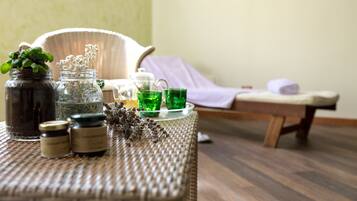 Relax in a serene spa setting with a wicker table and chair, perfect for unwinding.