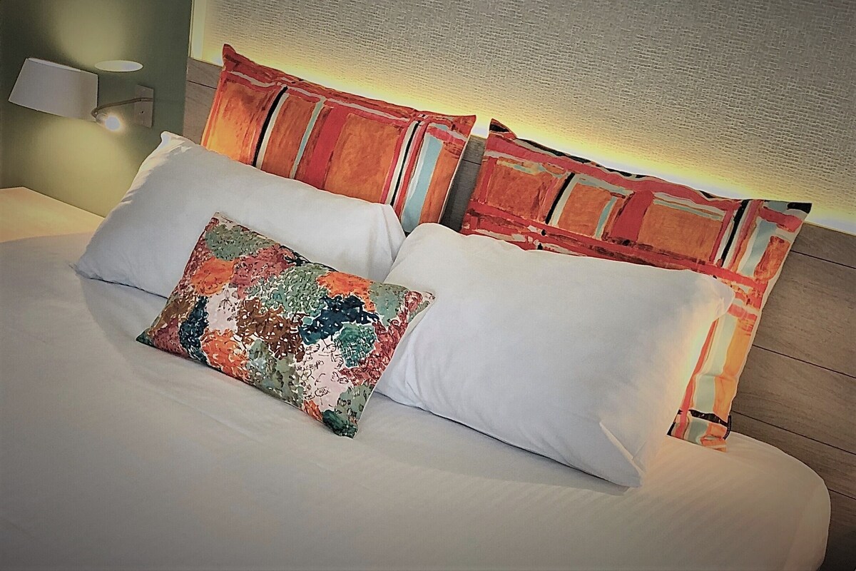 Premium bedding, desk, laptop workspace, soundproofing