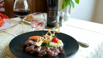 A plate of food with a fork on the table.