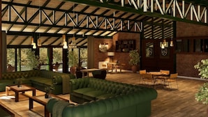 A spacious indoor area with a green sofa set, wooden tables, and a brick wall. - Valle Andino  (Uspallata)