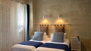 A double bed with two pillows, a bedside table, and a nightstand. - Auberge Le Colombien - Hôtel Restaurant (Villandry)