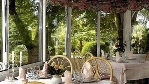 A table set for dining with a view of lush greenery outside. - Hermitage (Buzancais)