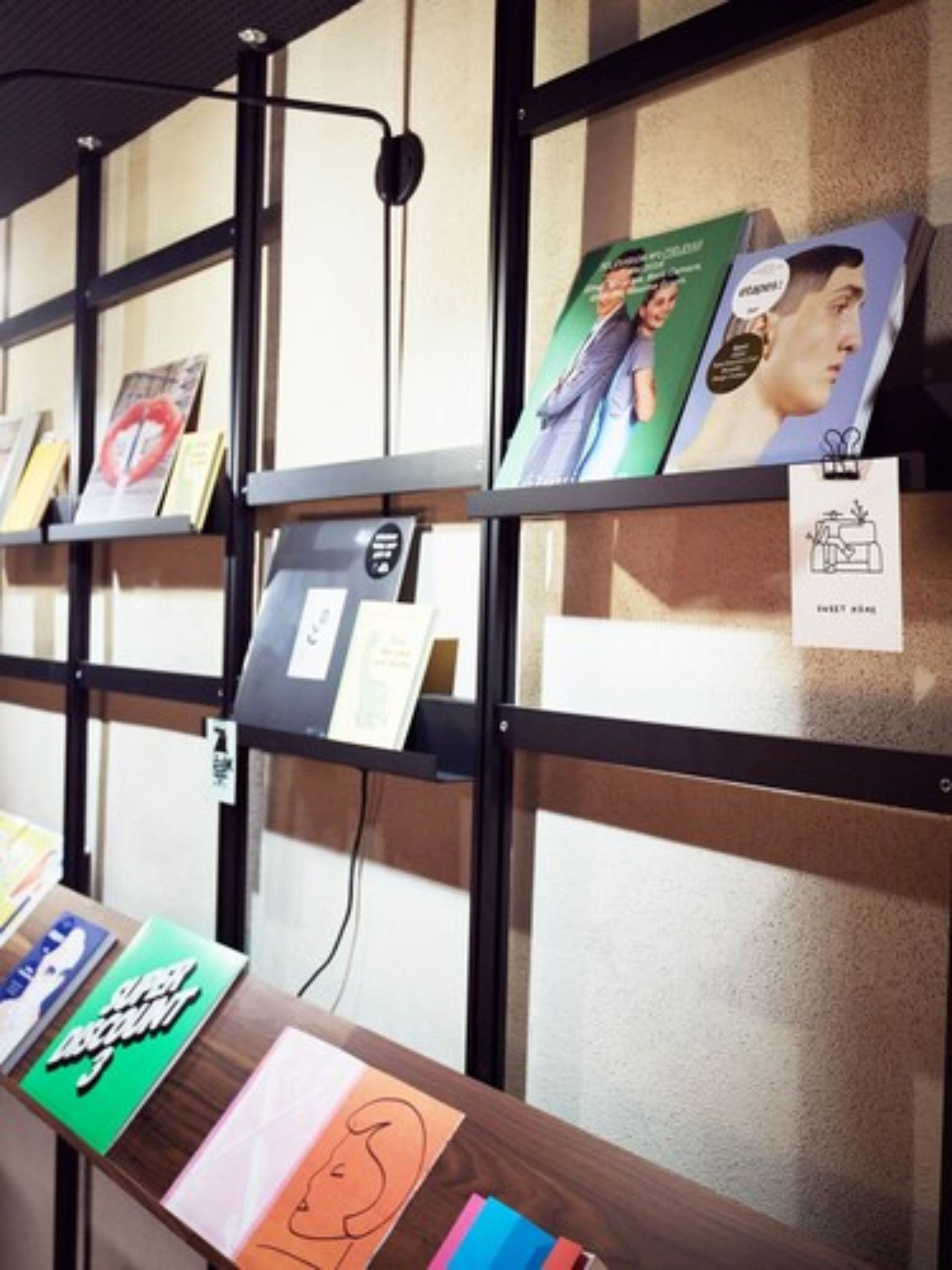 A display of books on shelves with labels indicating different sections.