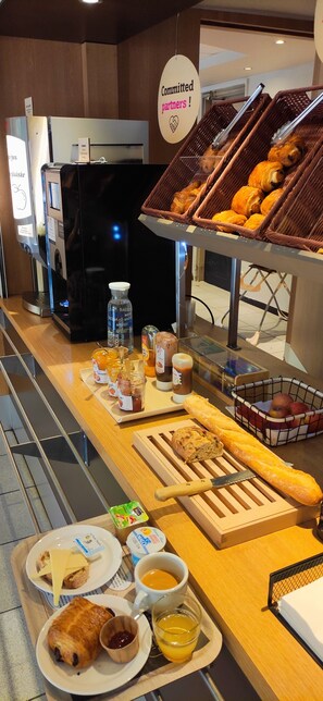 A breakfast buffet with various food items and beverages.