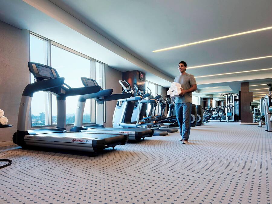 A gym with treadmills, weights, and exercise machines.