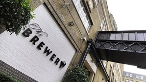 A building with a sign that reads "BREWERY" and a metal structure above it. - Montcalm Brewery, London City (London)