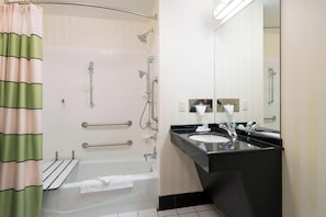 A bathroom with a shower, grab bars, a sink, and a mirror. - Fairfield Inn & Suites Huntingdon Route 22 Raystown Lake (Huntingdon)