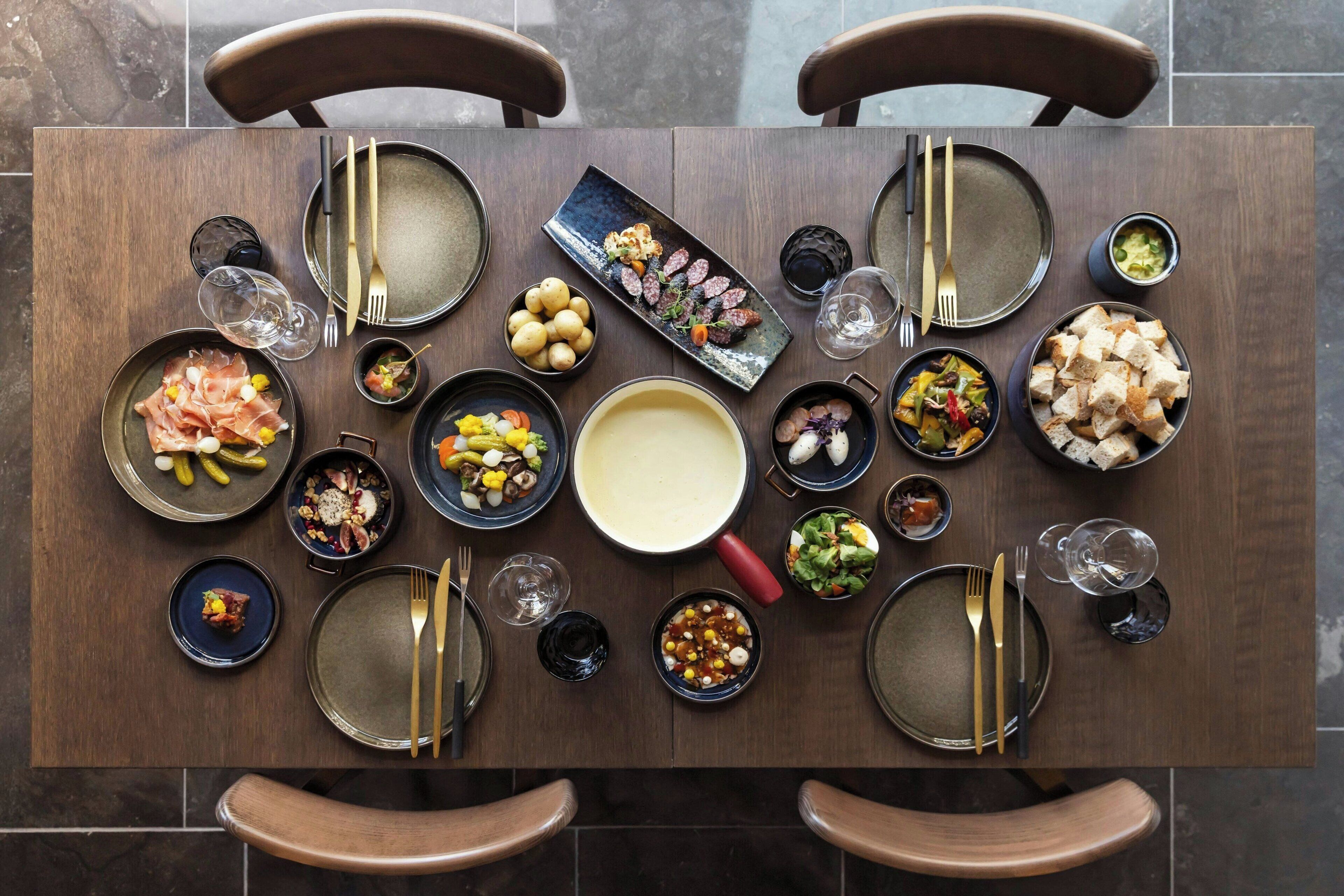 A dining table set with various dishes, plates, and cutlery.