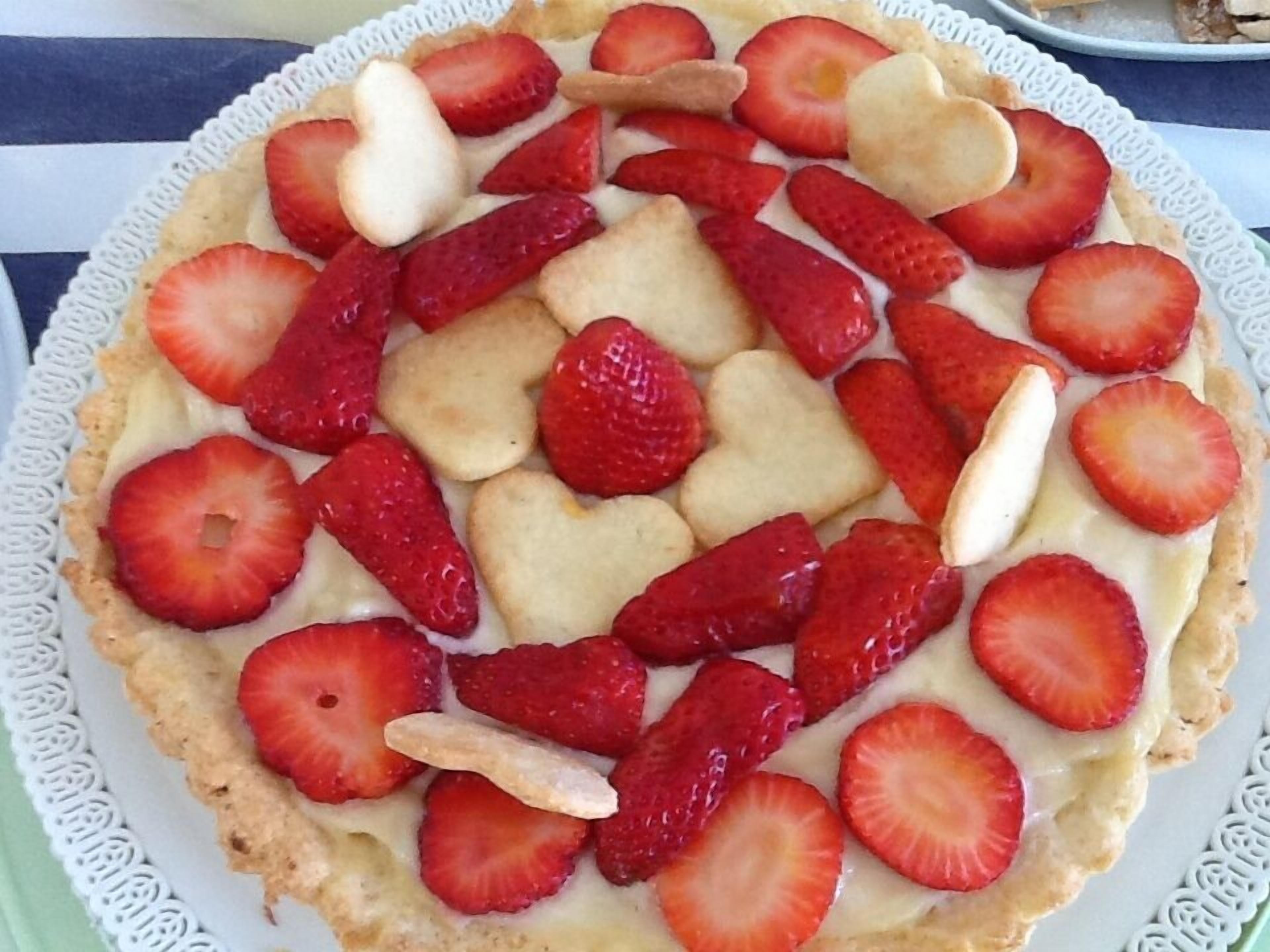 A dessert with strawberries and cookies on a plate.