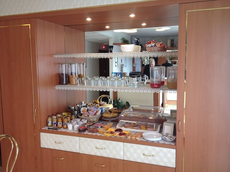 A buffet setup with various food items and beverages.