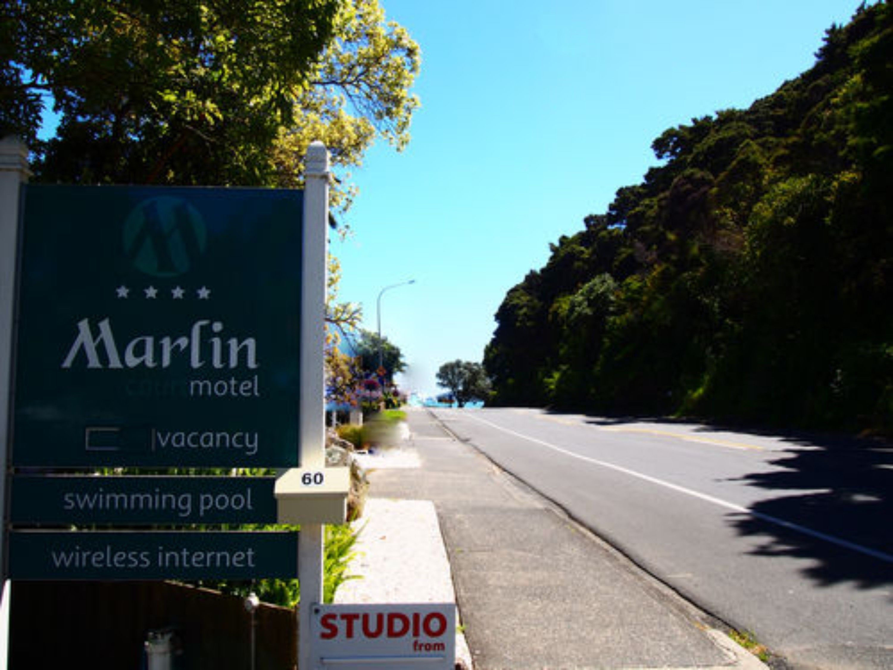 A Marlin Motel sign with amenities including a swimming pool and wireless internet.