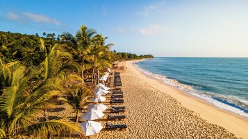 On the beach, white sand, free beach cabanas, sun-loungers