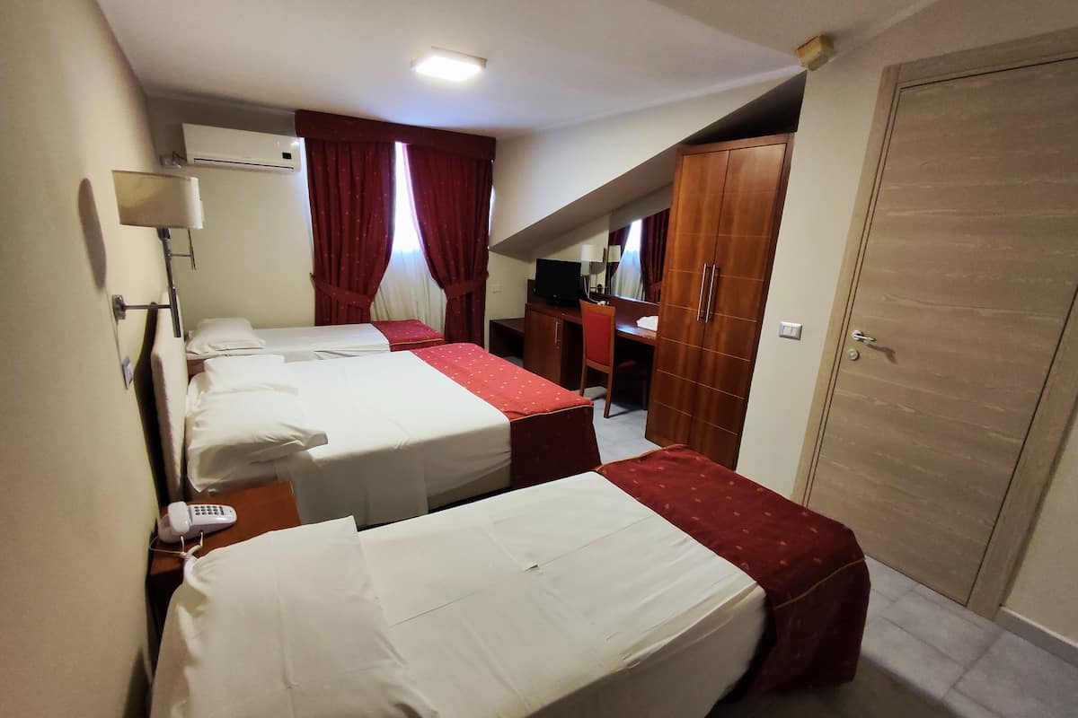 Superior Triple Room | Minibar, in-room safe, desk, iron/ironing board