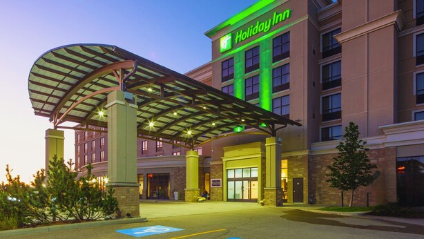 A Holiday Inn hotel with a covered entrance, multiple floors, and a brick facade. - Holiday Inn Hotel & Suites Red Deer South by IHG (Red Deer)