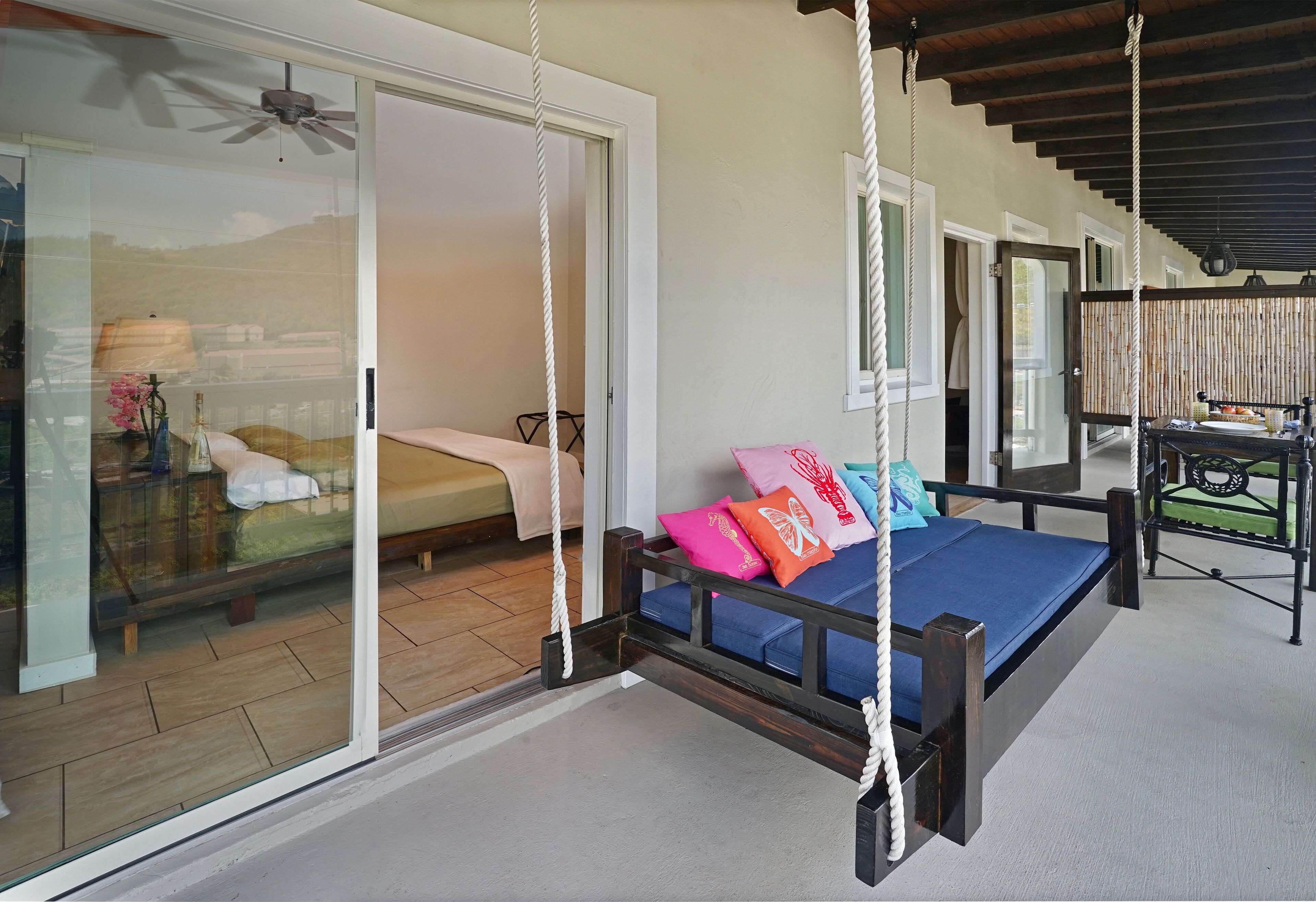 A bedroom with a bed, a window, and a door.