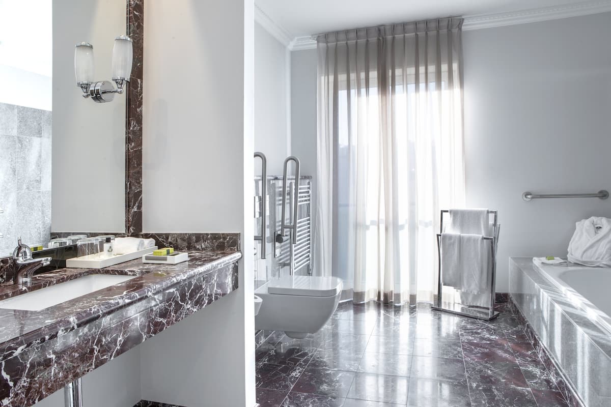 Combined shower/bathtub, designer toiletries, hair dryer, bathrobes