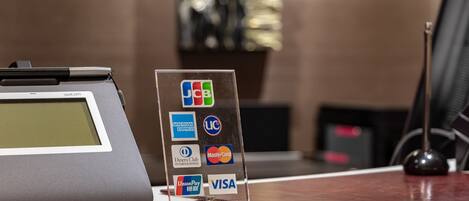 A payment terminal with various card logos, including Visa and MasterCard, and a UnionPay logo.