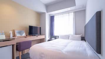 A hotel room with a bed, a desk with a television, a mirror, and a window with curtains.