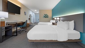 A hotel room with a large bed, a desk with a chair, a flat-screen TV, and a bedside table. - Comfort Suites Lewisburg near University (Lewisburg)