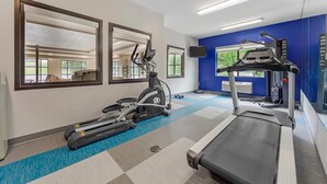 A gym with treadmills, stationary bikes, and a mirror. - Comfort Suites Lewisburg near University (Lewisburg)